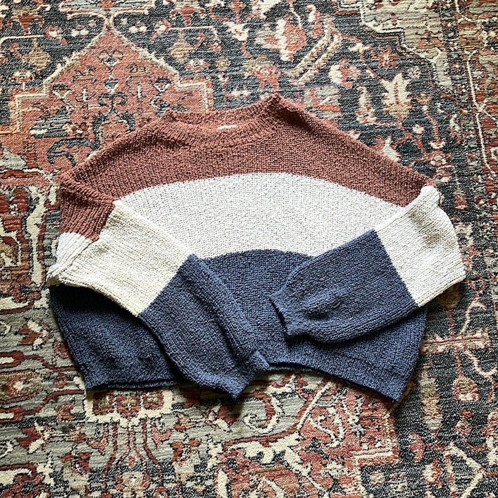 Copped striped brown, cream, and blue sweater.
